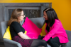 People chatting against a yellow background