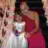 Suzanne and her daughter smile together for a picture at a family celebration