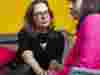 People having a serious conversation against a yellow background