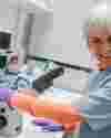 Judy Murray Using Microscope And Smiling